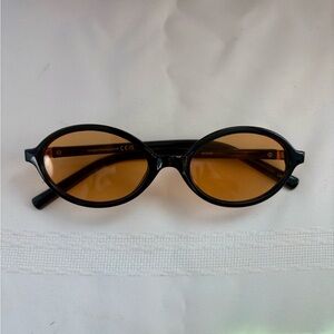 Oval glasses black frames and light brown lenses